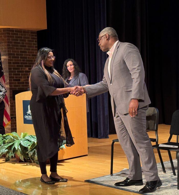 Mirianny Tifa Paulino (left) is welcomed into the Phi Theta Kappa Honor Society by OCC President Dr. Warren Hilton (right).