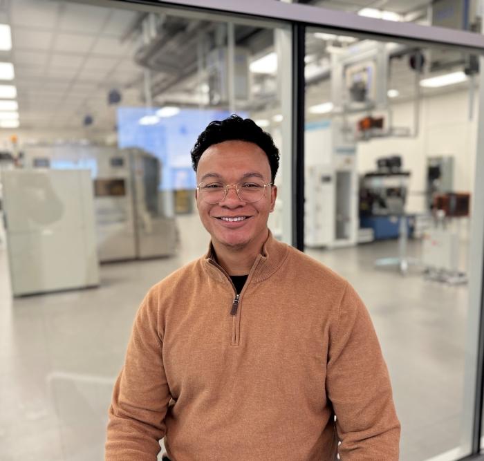 RJ Tinsley '25 is pictured in front of OCC's Micron Cleanroom Simulation Lab. Tinsley is a Dry Etch Process Technician at Micron in Boise, Idaho. He visited campus in October and saw OCC's new facilities for the first time.