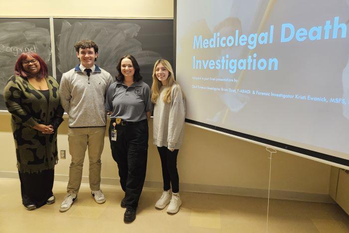 Criminal Justice Club Officers pictured with Taylor Bourdan (dark gray shirt) of the Onondaga County medical Examiner's Office are (left to right) Dionnarae Jones, Aidan Mott, and Harley DeOrdio.