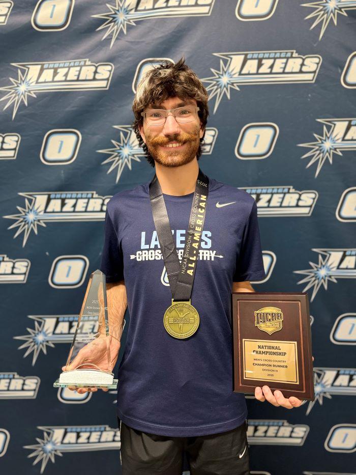 Paul Clark and his hardware! Left to right: his National Cross Country Men's Athlete of the Year trophy, All-American medal, and Men's Cross Country National Championship plaque.