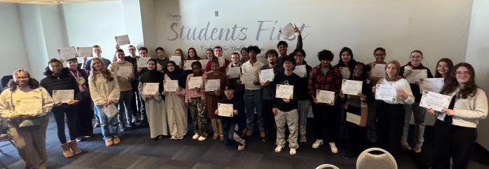OCC Early College students hold up their honor roll certificates. They were recognized during a ceremony on campus.