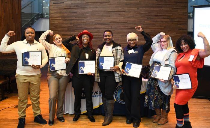 Real Life Rosie program graduates pose for a group photo at their graduation ceremony on the Onondaga Community College campus.