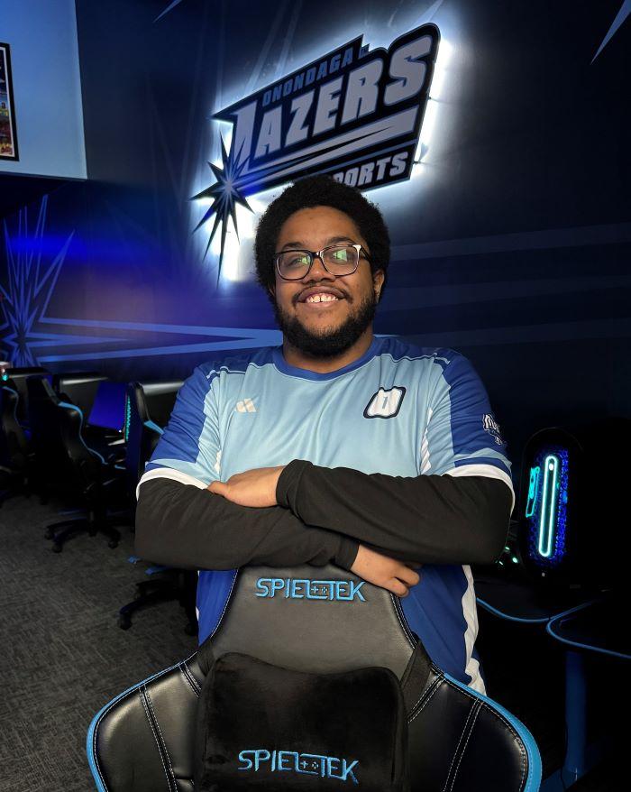 Nimley Bestman is pictured in OCC's Esports Arena. "It's cool here. When it's time for a match we dim the lights, turn on the sign, turn on blue LED lights. it creates a really cool environment to play in."