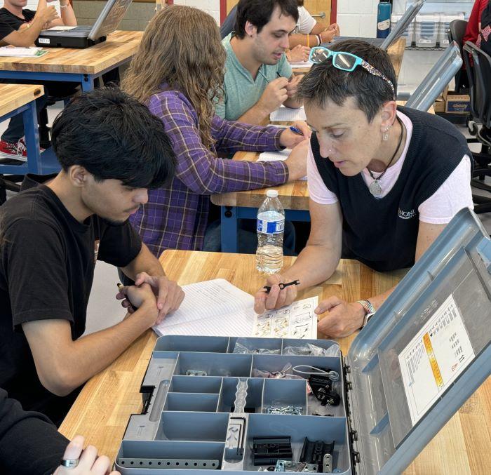 Professor Colleen Stevens (right) teaches Electromechanical Technology and Math at Onondaga Community College.