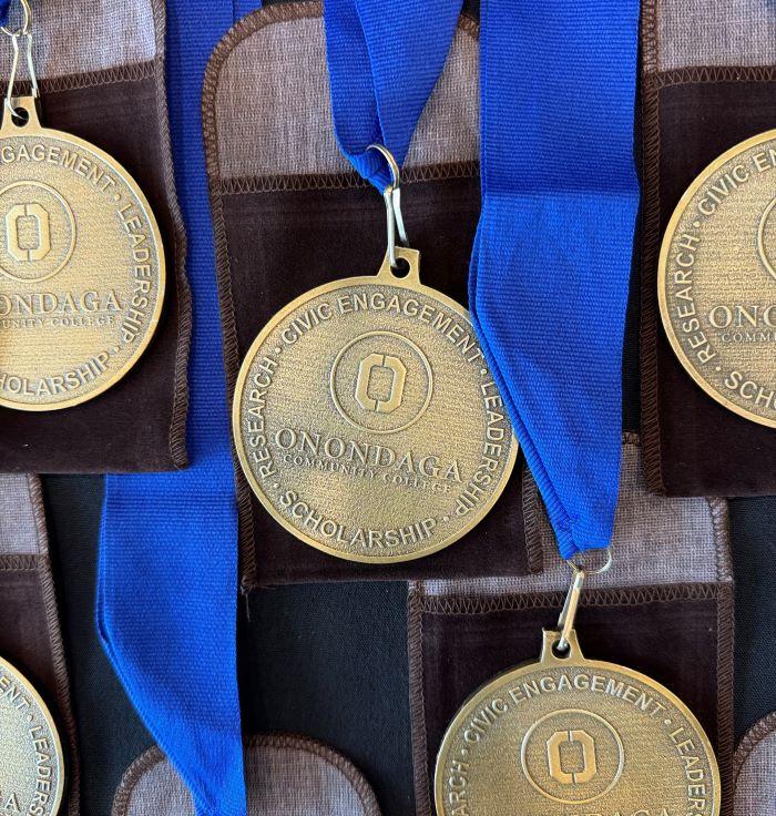 Onondaga Community College Pinnacle Awards recipients were honored with these medals which they will wear at commencement May 16.