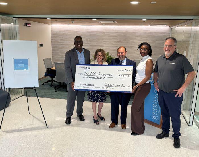 The National Grid Foundation's check presentation to Onondaga Community College included (left to right) OCC's Warren Hilton, Louis Noce, and Terry Hopkins, and National Grid's Kahri Fuller and Alberto Bianchetti.