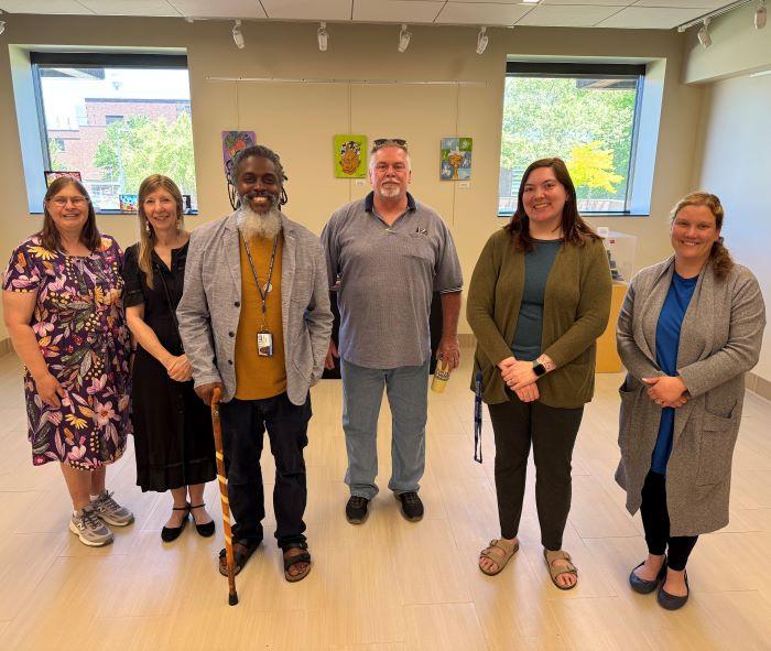 Onondaga Community College faculty and staff gathered for a reception celebrating their "On My Own Time" art exhibit.
