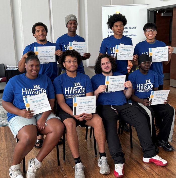 The first group of Syracuse City School District students to graduate from the Bridge to Manufacturing Learning Community program proudly pose for a group photo.