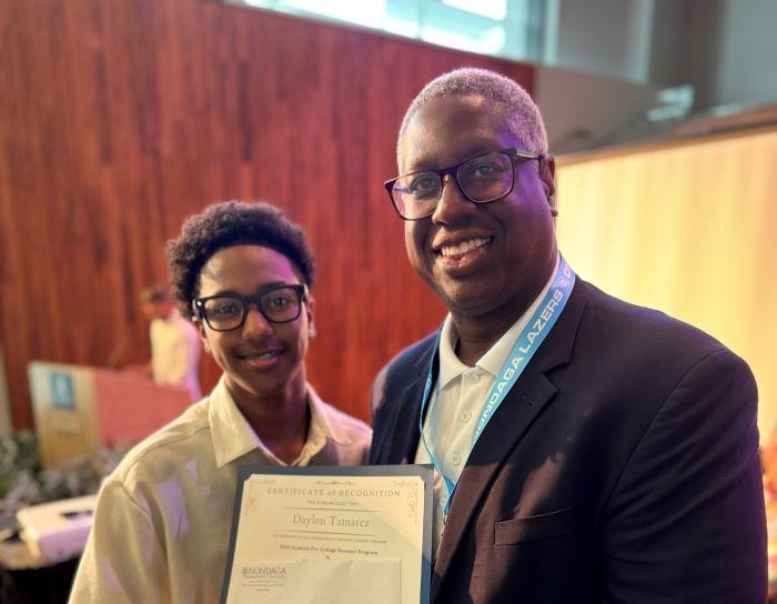 Daylen Tamarez (left) is congratulated by Onondaga Community College President Dr. Warren Hilton for completing the Sankofa Pre-College Summer Program. Tamarez came to OCC from New York City where he will be a high school junior this fall.