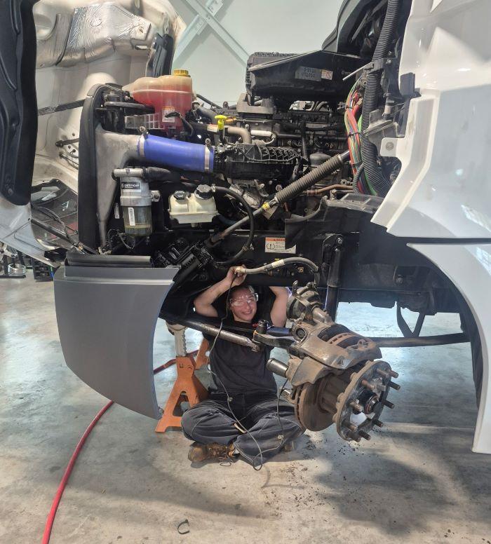 Alaina Kelsey is enjoying her hands-on learning opportunities in Onondaga Community College's new Commercial/Heavy Equipment Service Repair program. She's working on a 2023 Frieghtliner truck that was loaned to OCC by Tracey Road Equipment.