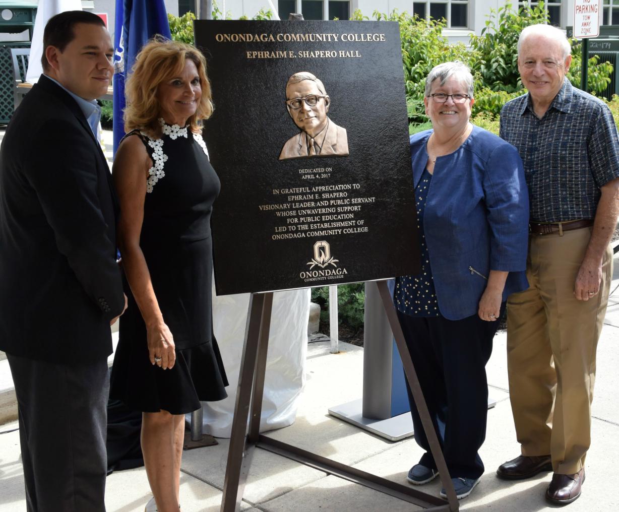 Paying tribute to Ephraim E. Shapero are (left to right) Onondaga County Legislature Chairman J. Ryan McMahon, Shapero's daughter Ava Raphael, OCC President Casey Crabill and former Onondaga County Executive Nicholas J. Pirro.