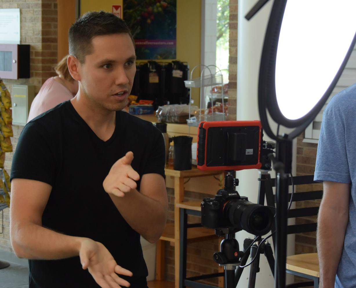 James Domroe, '02 conducts an interview during a video shoot in the Whitney Applied Technology Center. Domroe's &quot;325 Productions&quot; is a growing and successful content creation and social media marketing company in Central New York.
