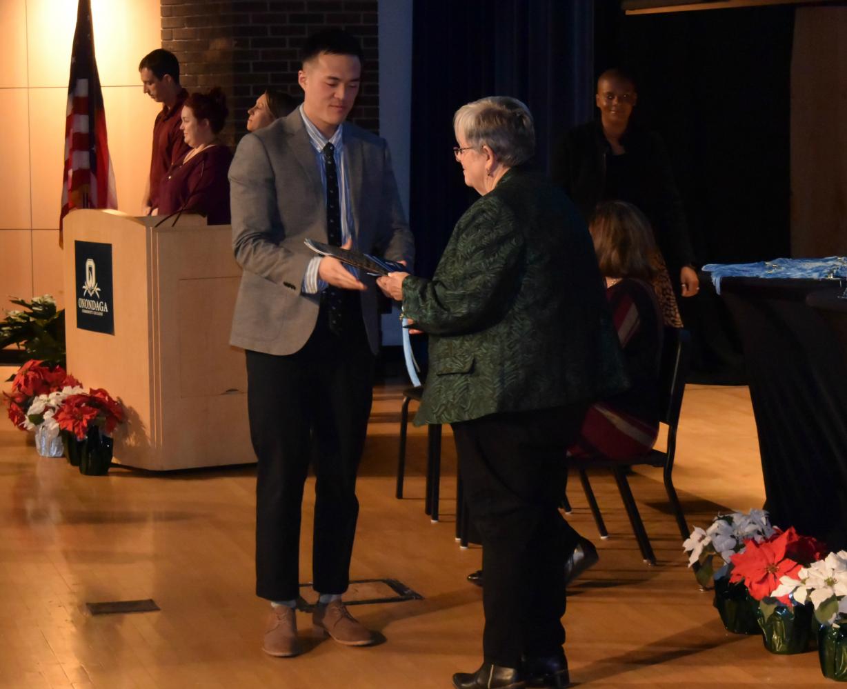 Seth Bae (left) is congratulated by OCC President Dr. Casey Crabill (right) at the December graduation ceremony Tuesday in Storer Auditorium.