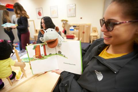 Woman reading a book to a child