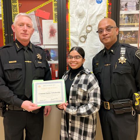 Saray Quevedo (center) receives her Criminal Justice Scholarship from Onondaga County Sheriff Toby Shelley (left) and Crayg Dykes (right).