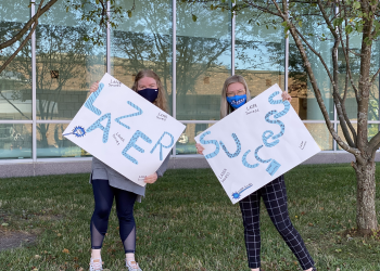 Student & Employee with Lazer Success Signs