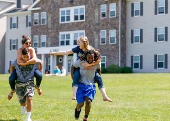 Students playing games by the res halls
