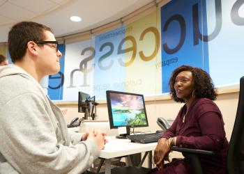 Student meeting with employee