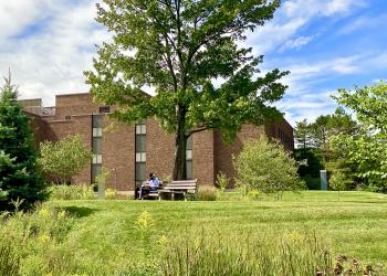 Student studying on a bench